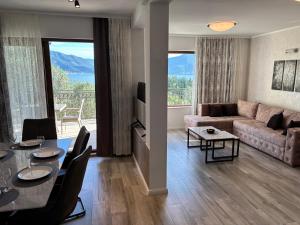 a living room with a table and a couch at Boka Hub Apartments in Krašići