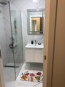 a bathroom with a shower and a sink and a mirror at Sarah Central City Apartment-Bar in Bar +12 photos