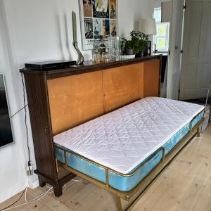 a bed in a room with a wooden frame at Strandvænge 12, 4600 Køge in Køge