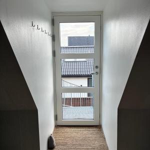 a door leading into a room with a window at Strandvænge 12, 4600 Køge in Køge