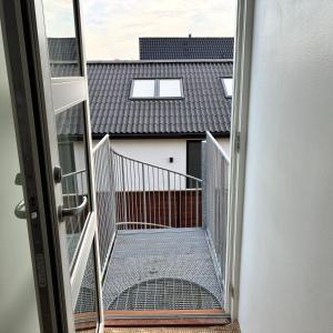 an open door to a balcony with a building at Strandvænge 12, 4600 Køge in Køge