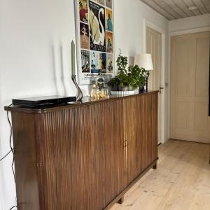 a wooden cabinet with a lamp on it in a room at Strandvænge 12, 4600 Køge in Køge +22 photos