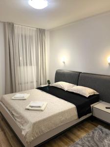 a bedroom with a large bed with two trays on it at Vila Pogled in Novi Sad +30 photos