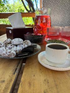 a table with a plate of donuts and a cup of coffee at Lucy Guest House in Garni +12 photos