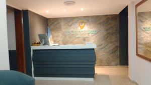 a dume surf arena sign on a wall in a lobby at Hotel Punto Sur Avenida in Malargüe