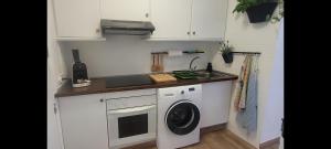 a kitchen with a washing machine and a sink at Calpe vistas al mar in Ifach