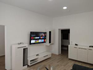 a living room with a flat screen tv on the wall at HOME Prime Stay Chemnitz in Chemnitz