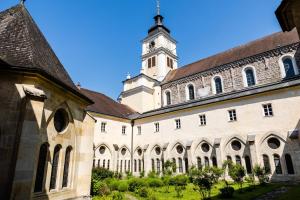 a large building with a clock tower on top at Zisterzienserstift Lilienfeld in Lilienfeld