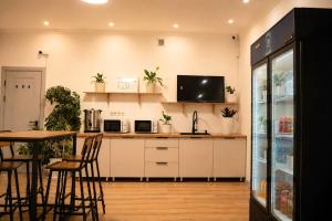 a kitchen with white cabinets and a table with chairs at Babushka House Hostel in Bishkek