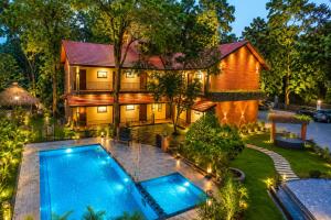 an overhead view of a house with a swimming pool at Athirapilly Fernvalley Resort in Athirappilly