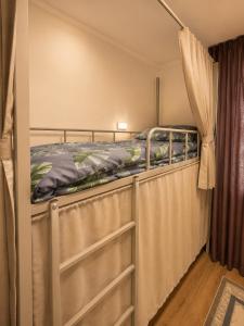 a bedroom with a bunk bed in a room at Babushka House Hostel in Bishkek