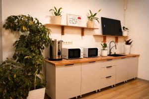 a kitchen with a counter with two microwaves at Babushka House Hostel in Bishkek
