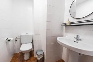 a white bathroom with a toilet and a sink at Bright & Spacious Apartment in Nerja Centre in Nerja +28 photos