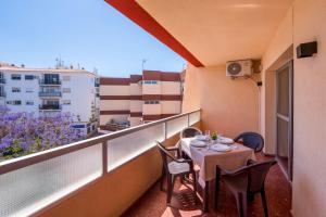a balcony with a table and chairs on it at Bright & Spacious Apartment in Nerja Centre in Nerja