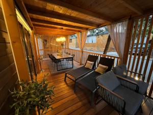 a screened in porch with a couch and a table at Max Mobile Home in Biograd na Moru