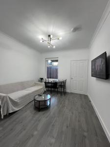 a living room with a couch and a table at Central Kettering Apartment by SJP Ideal for up to 3 Guests in Kettering