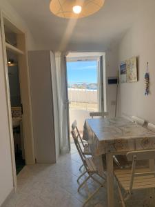 a dining room with a table and a window at Casa Il Timone Indipendente in Ponza +18 photos