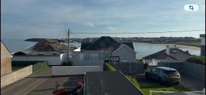 a person on a motorcycle parked next to a house at Blackhill Lookout in Portrush