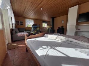a bedroom with a bed and a living room at Sweet guest house with a view in Sävsjö