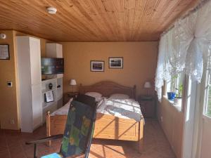 a bedroom with a bed and a wooden ceiling at Sweet guest house with a view in Sävsjö