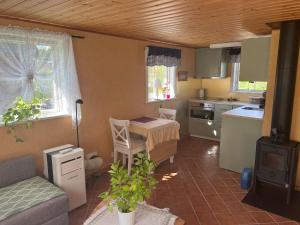 a kitchen with a table and a couch and a table at Sweet guest house with a view in Sävsjö
