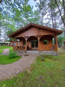 a wooden pavilion in a park with trees at Chalet confort in Saint-Rémy