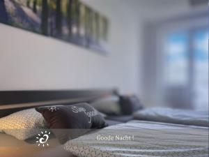 a bedroom with a bed with two pillows on it at Penthouse de Ool Blick auf das Wattenmeer in Neufeld