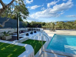 a swimming pool in a yard with a lawn at Villa Maginja in Sutivan