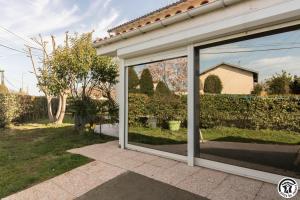 a sliding glass door on a house at Maison venitia t5 in Aussonne
