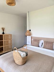 a bedroom with a bed with a basket on a rug at Moon Lake Bicaz - Aurora Garden in Buhalniţa