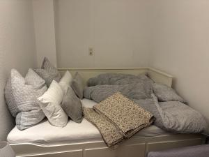 a bed with several pillows on top of it at Dorfblick Barweiler in Barweiler