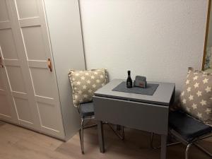 a small table with two chairs and a bottle on it at Dorfblick Barweiler in Barweiler