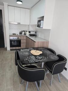 a kitchen with a table and chairs in a kitchen at Apartamento Céntrico y Equipado in Concepción