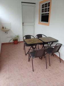 a wooden table and chairs in a room at Cassiane Apartments in Thibaud
