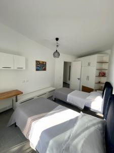 a bedroom with two beds and a table in it at SunkissedVilla in Draç +18 photos