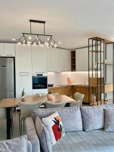 a living room and kitchen with a couch and a table at SunkissedVilla in Draç