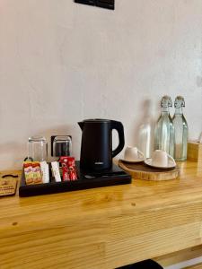 a counter with a coffee maker and bottles on it at Serene Dhigurah in Dhigurah