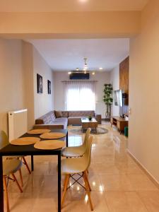 a living room with a table and a couch at Asul Seaside Retreat in Stavros