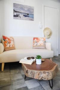 a living room with a couch and a wooden coffee table at Blue horizon apartment & suite in Kalymnos