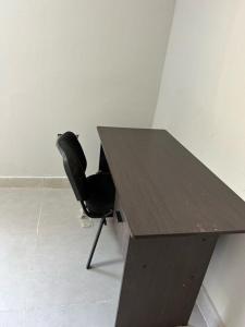 a desk with a black chair next to a table at Mine Lux Rentals in Thabazimbi