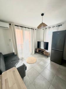 a living room with a couch and a refrigerator at Cala Serena Saint Cyprien in Lecci