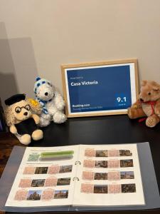a table with stuffed animals and a book on it at Casa Victoria in Pécs