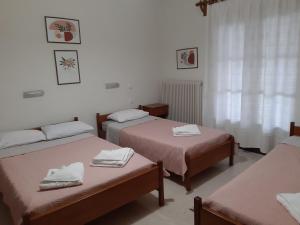 a room with two beds with towels on them at Giotis apartments in Leptokarya