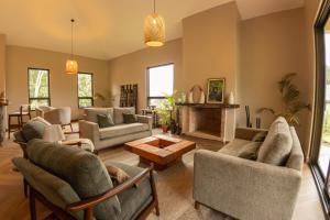 a living room with couches and a fireplace at Huduma Bwindi Lodge in Kisoro