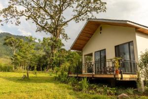 a house in the middle of a field at Huduma Bwindi Lodge in Kisoro +30 photos