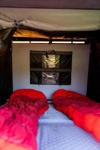 two red pillows on a bed in a tent at lodi campers rental in Theth +46 photos