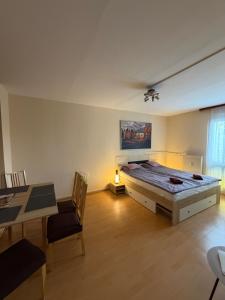 a large bedroom with a large bed and a table at Casa Cristina in Pécs