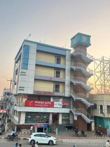 a large building with cars parked in front of it at Vybhav Residency in Anantapur
