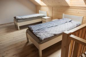 a bedroom with two beds in a room at Agroturystyka Oliweczka 31 in Potok Wielki