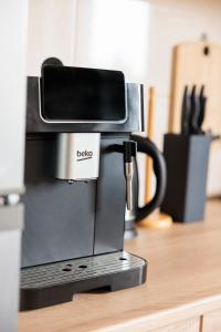 a coffee maker sitting on top of a counter at Agroturystyka Oliweczka 31 in Potok Wielki